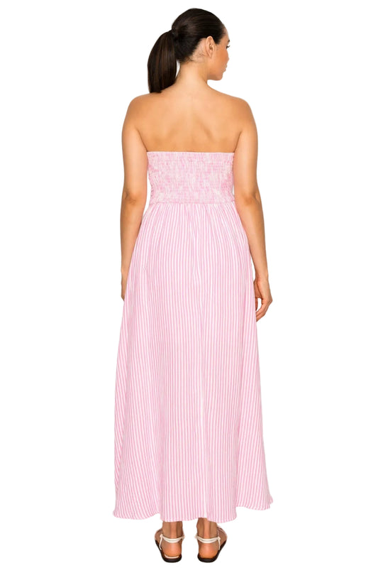 Woman wearing a pink strapless dress with white stripes on a white background