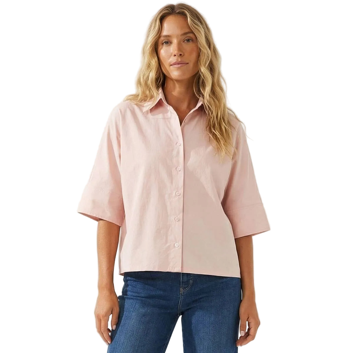 Woman wearing a light pink shirt and blue jeans on a white background