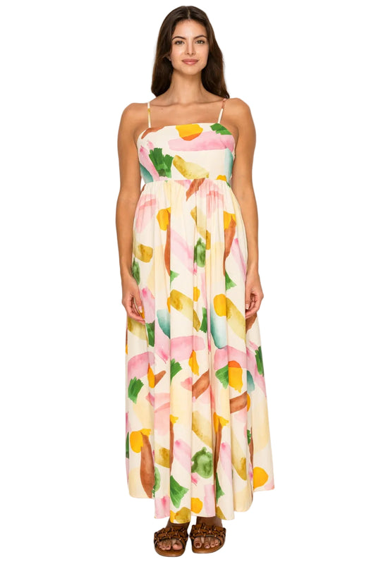 Woman wearing a colorful fruit-patterned dress on a white background