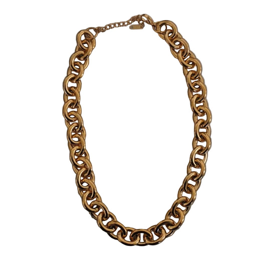 Gold chain necklace on a marble surface