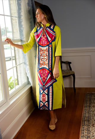 A vibrant full-length caftan dress in Tigers Eye with a notched neckline and 3/4 sleeves.