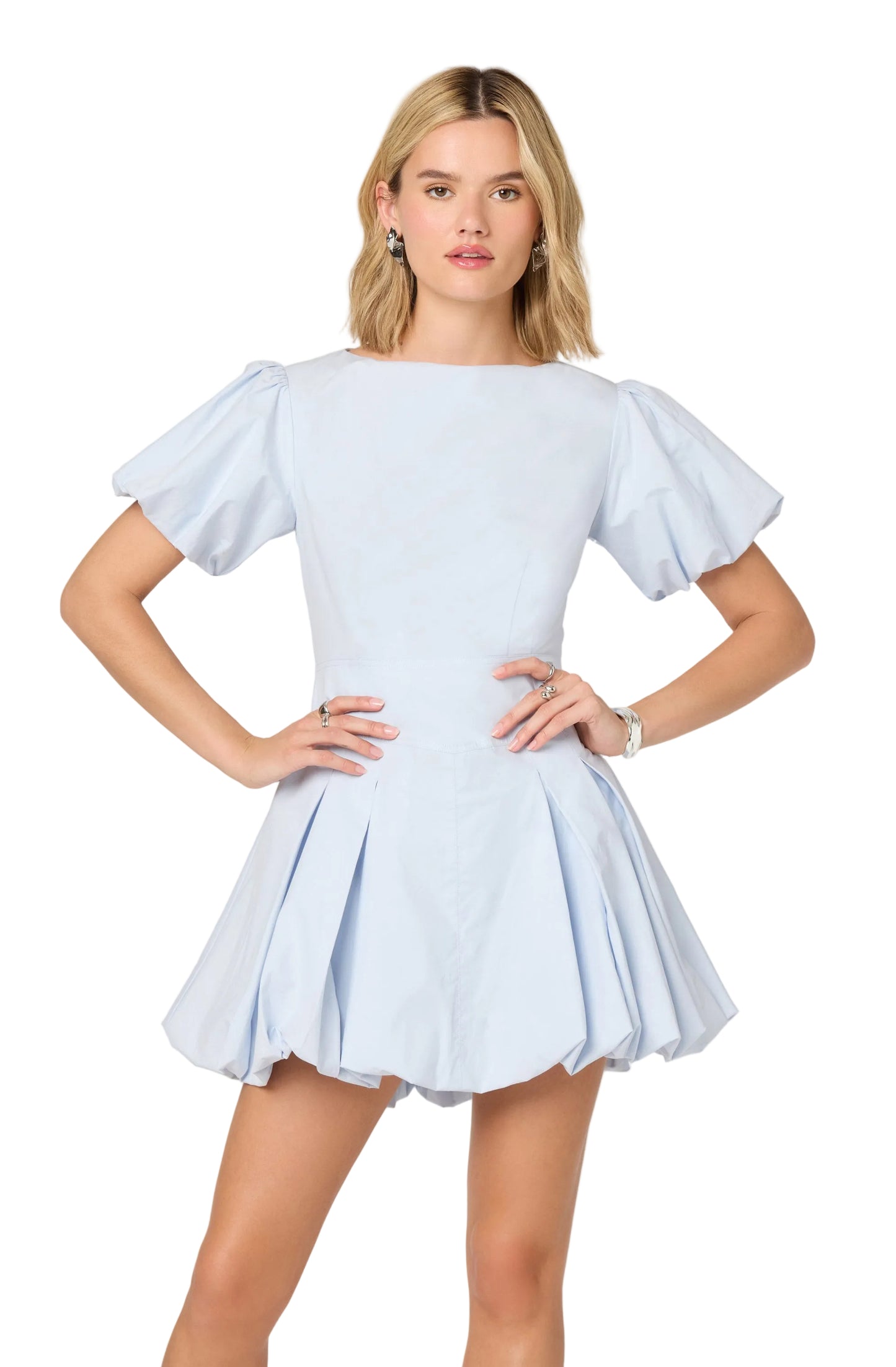 Woman wearing a light blue dress with ruffled sleeves on a white background