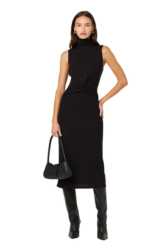 Woman wearing a black sleeveless dress with a plain background