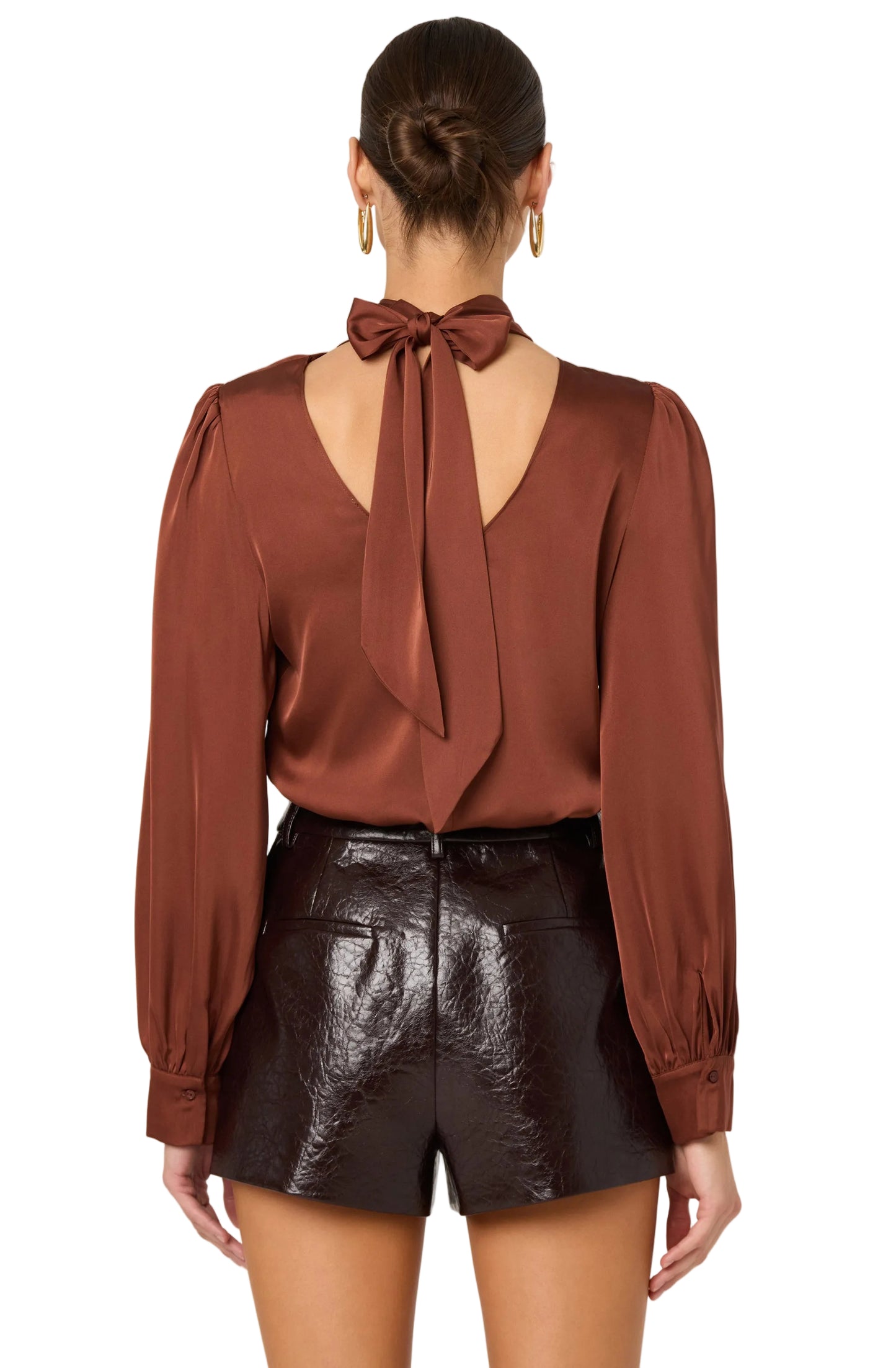 Brown blouse with a bow detail on the back worn by a person, against a white background