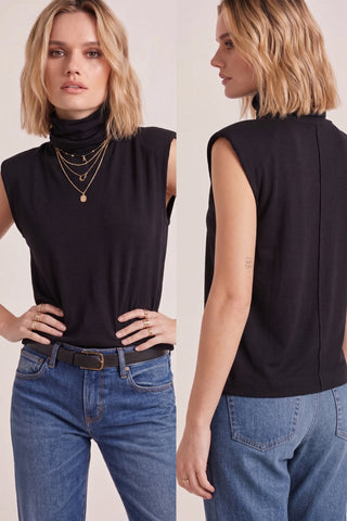A black mock neck top with raglan cap sleeves worn by a model with short blonde hair.