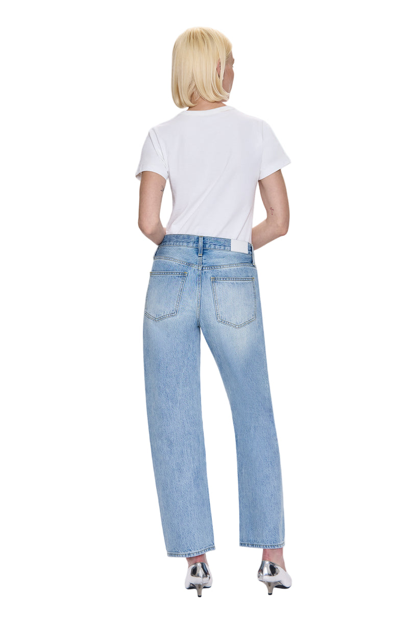 Person wearing light blue jeans and a white t-shirt on a white background