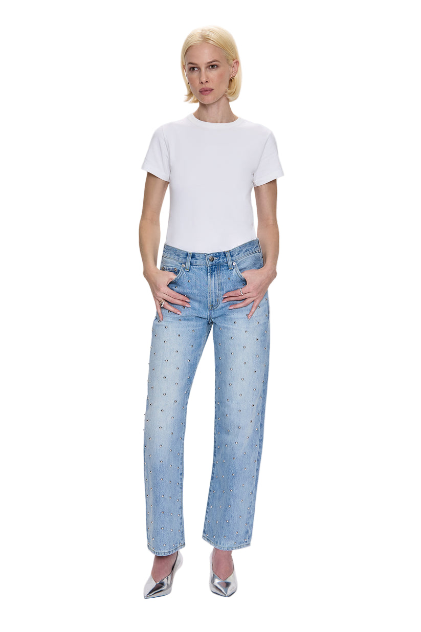 Woman wearing a white t-shirt and light blue jeans on a white background