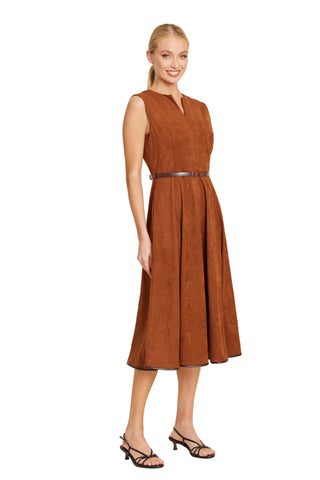 A woman wearing a desert-colored faux suede midi dress with a belted waist and notch neckline.