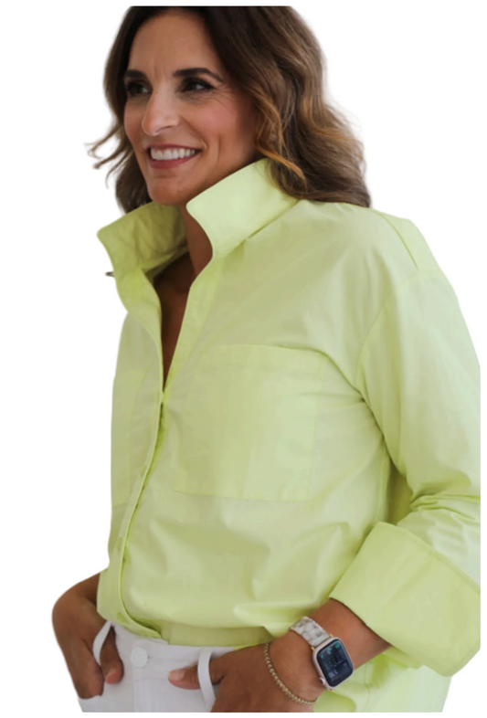 Woman wearing a light green jacket against a white background