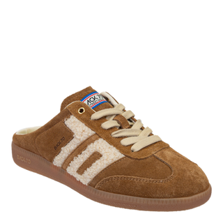 A pair of tobacco-colored slip-on sneakers with suede and teddy textile upper, stitched details, and a 1-inch heel.